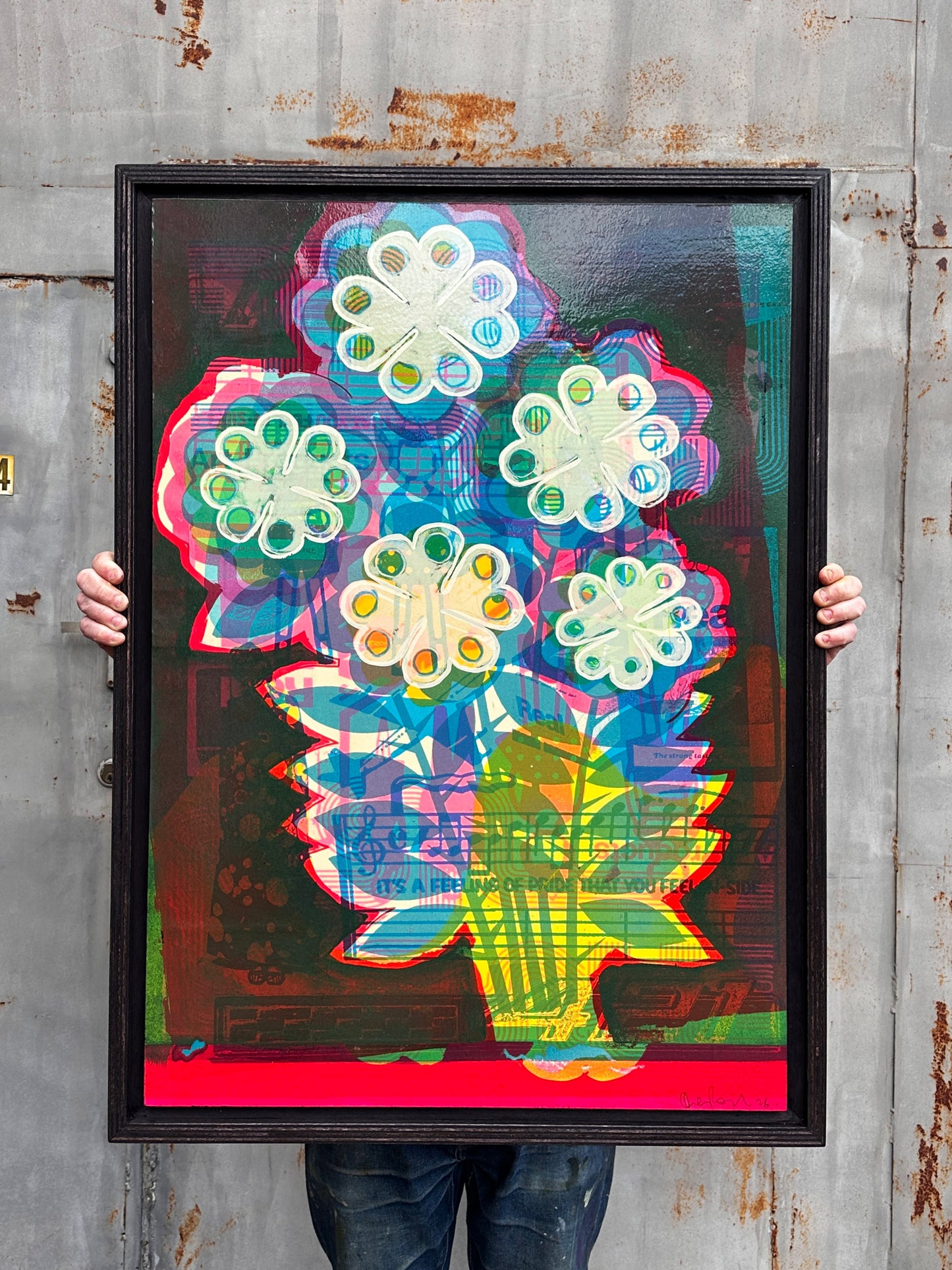 A Real Strong Taste original mixed media artwork by Oli Fowler, framed in dark stained birch, white pop flowers layered over collaged 1970s magazine pages and sheet music, red stripe along the base