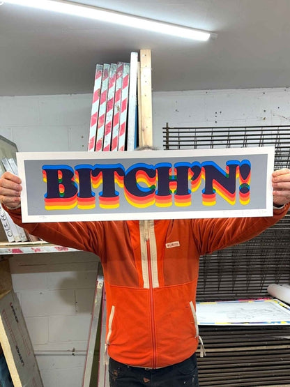 BITCH'N! hand-pulled screenprint by Oli Fowler — rainbow bubble letters on a grey background