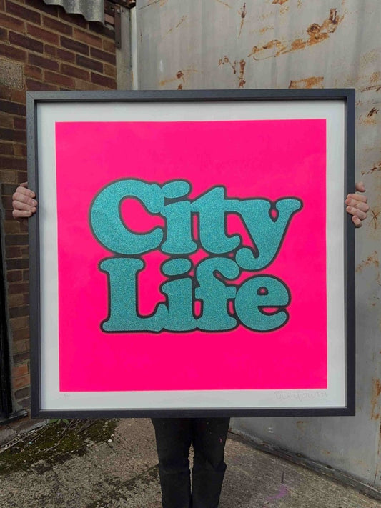 City Life XL hand-pulled screenprint by Oli Fowler. Bold teal glitter lettering on hot neon pink background.
