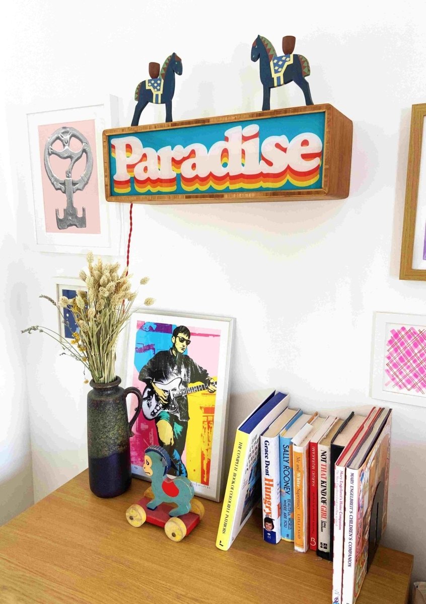 Illuminated light box, cyan and orange, retro 'Paradise' layered typography in wooden frame