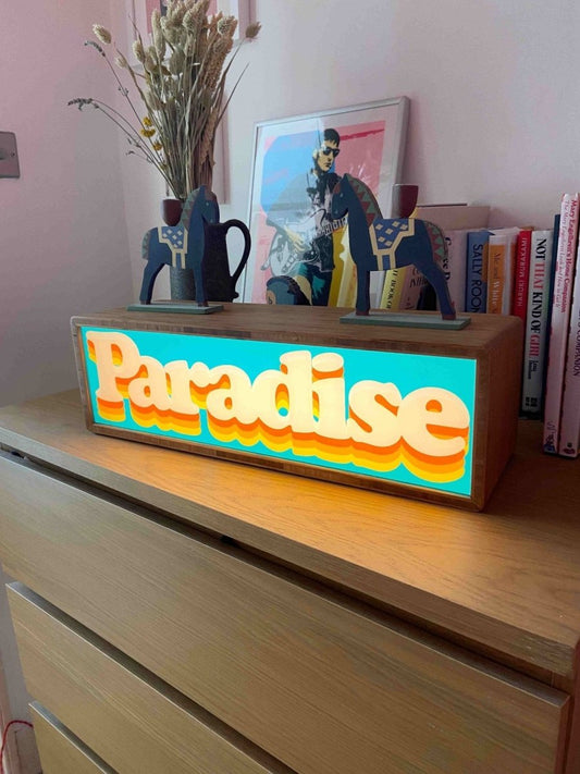 Paradise Light Box, hand-pulled screenprint by Oli Fowler, teal and orange retro typography in illuminated bamboo frame
