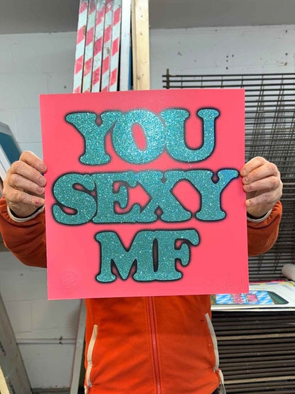 Hand-pulled glitter screenprint, turquoise and black on coral pink, bold 'You Sexy MF' text, edition of 100